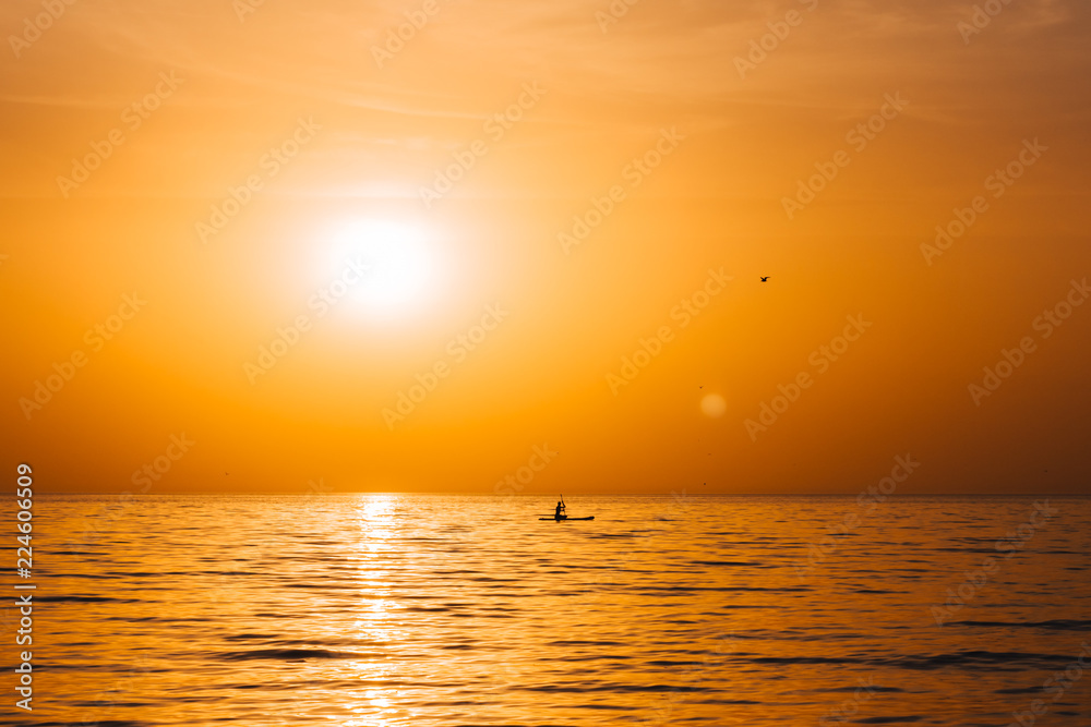 Paddle boarder in the sunset