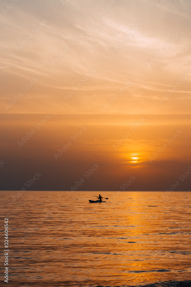 Paddle boarder in the sunset