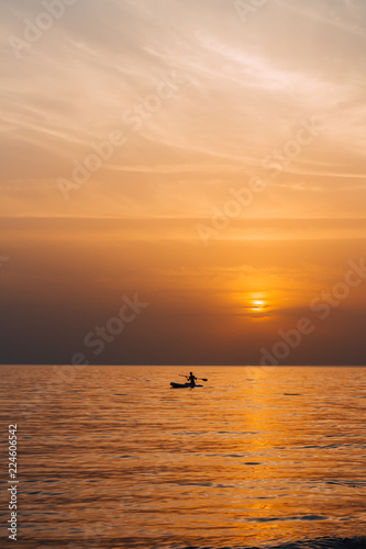 Paddle boarder in the sunset © baklykovadaria