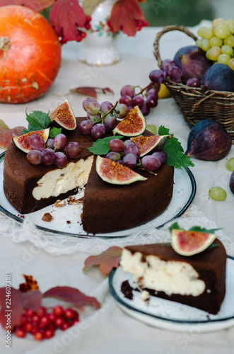 Autumn chocolate cake decorated with figs and grapes