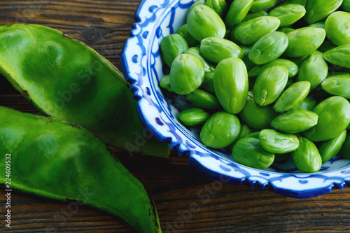 Parkia speciosa or English name is bitter bean, twisted cluster bean or stink bean and Thai name is sataw or sator  on wooden background. photo