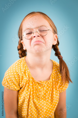 Snarky Little Girl with Glasses, Isolated on Teal