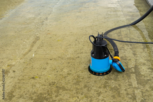 Submersible pump dewater construction site, pumping flood water sing deep well.
