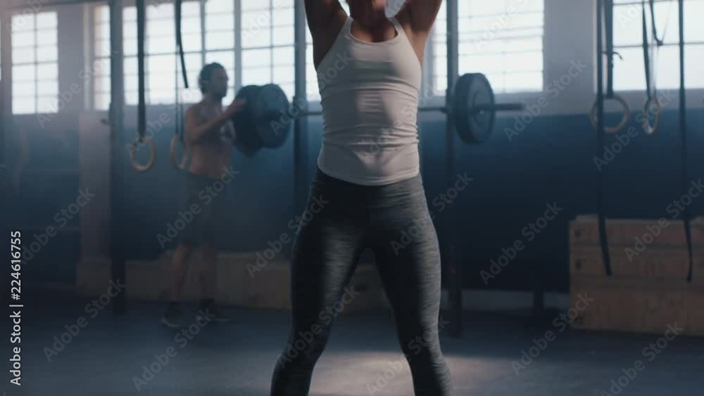 fitness woman bodybuilder training using medicine ball exercise intense strength workout challenge in gym tough sportswoman enjoying healthy lifestyle