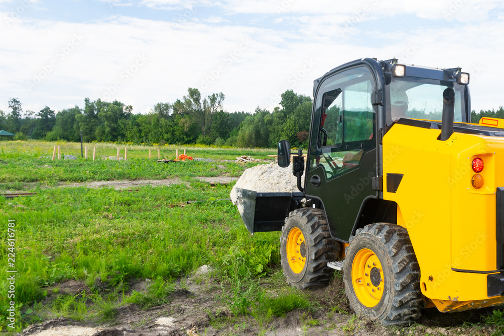 The loader took the sand into the bucket for construction work. The loader took the sand into the bucket for construction work.