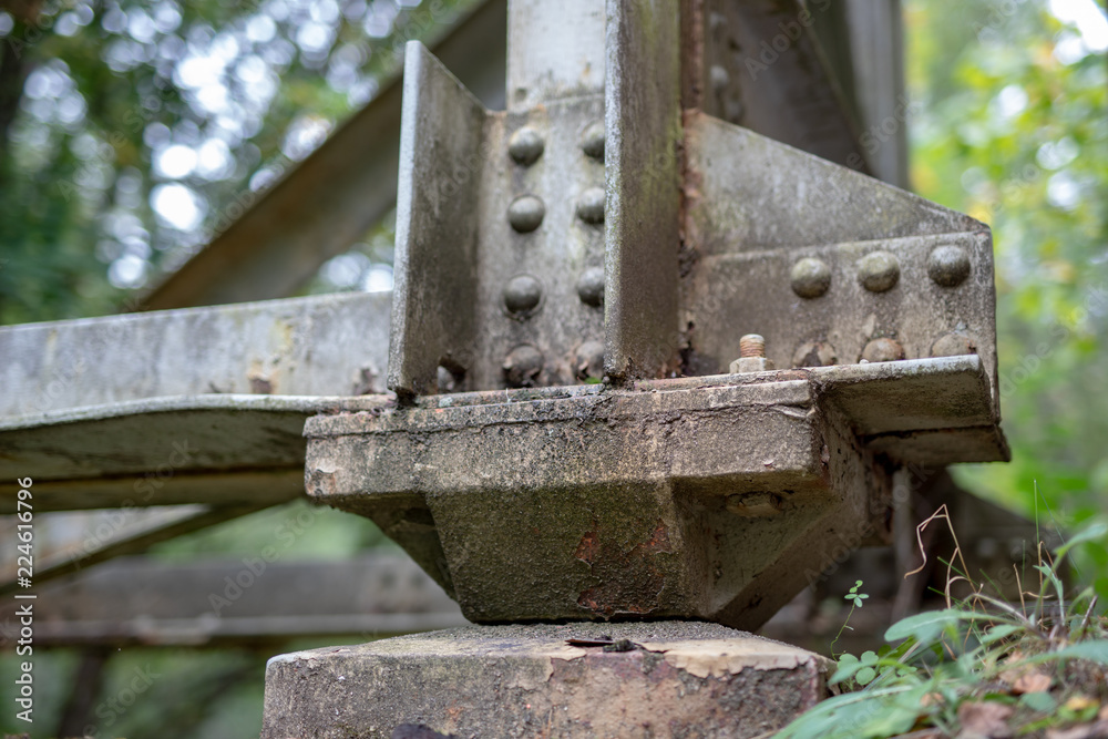 The old truss of the railway bridge. Steel construction connected by rivets.
