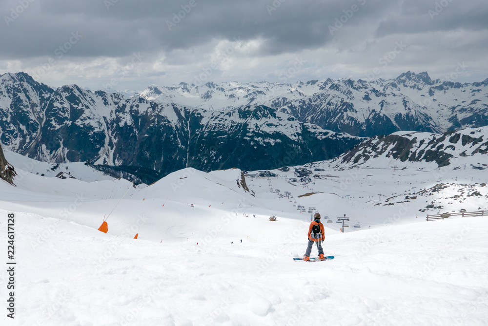 Snowboarder preparing for a ride on snowy slope in ski resort
