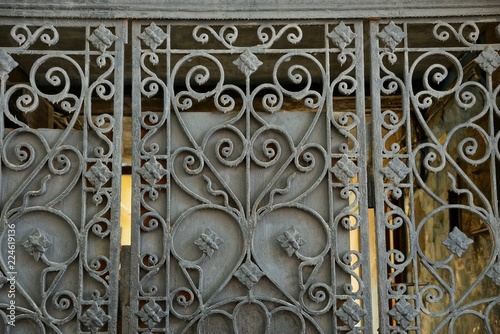 gray metal texture of an iron fence with a forged pattern