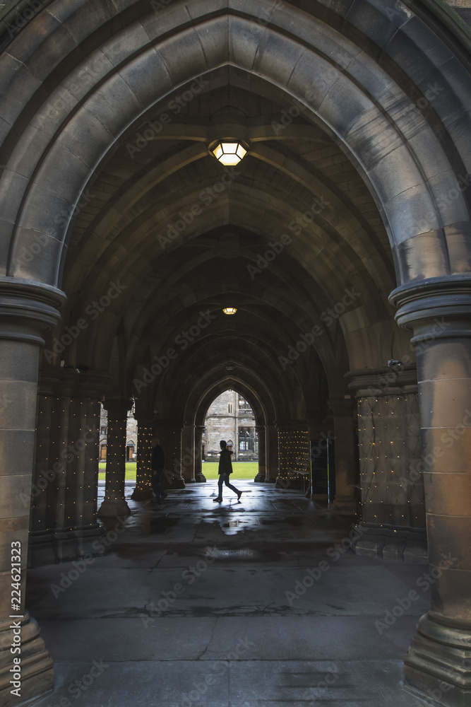 Student walking in the Glasgow University Cloisters