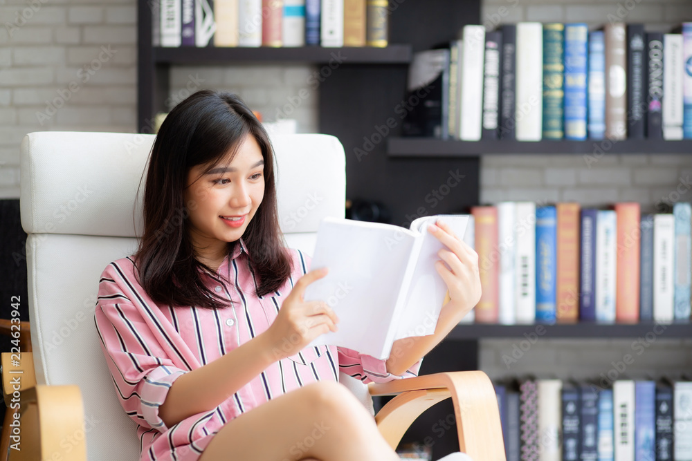 Beautiful of portrait young asian woman relax sitting reading book in living room at home, girl study literature, education and llifestyle concept. Beautiful of portrait young asian woman relax sitting reading book in living room at home, girl study literature, education and llifestyle concept.