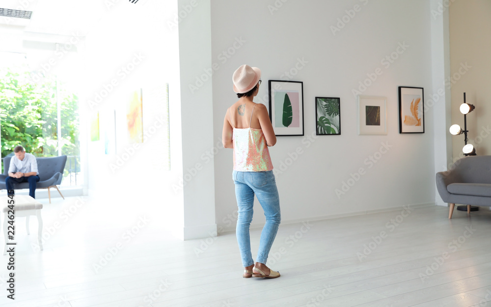 Young woman at exhibition in art gallery Young woman at exhibition in art gallery