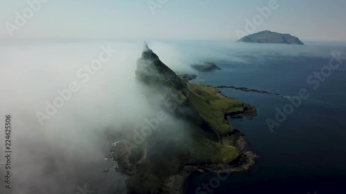 Aerial flight next to the famous Tindhólmur island in Faroe Islands