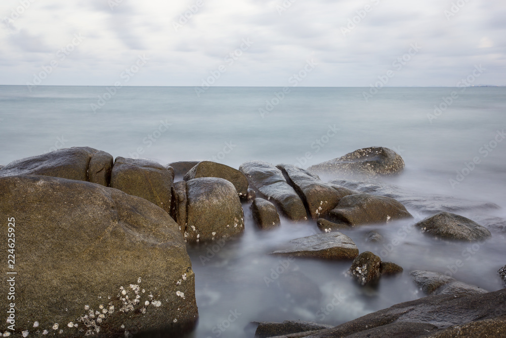 Obraz premium Long Exposure of Sunset at the sea,Larn hin khao , Rayong,Thailand , sunset at White rock beach , Rayong