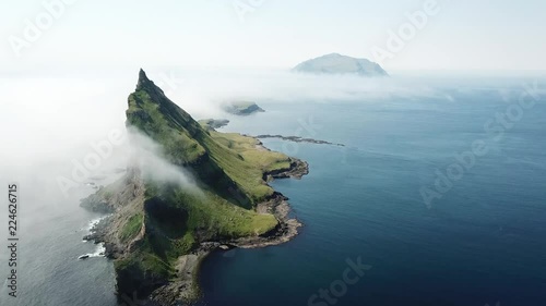 Aerial flight next to the famous Tindhólmur island in Faroe Islands