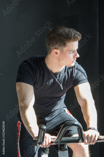 portrait of young man working out in a gym
