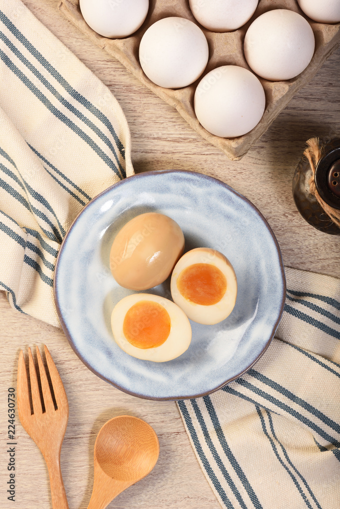 Plate of soft boiled eggs on wooden table Plate of soft boiled eggs on wooden table