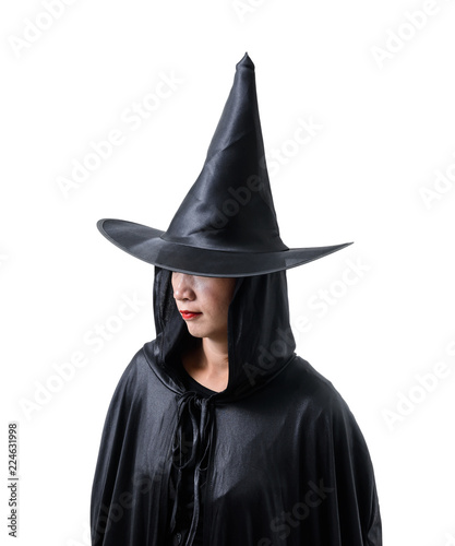 Portrait of woman in black Scary witch halloween costume standing with hat isolated on white background © sirastock