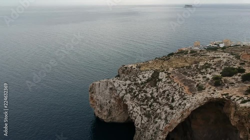 Revealing shot of blue groto and it's viewpoint, flying backwards. In Malta photo