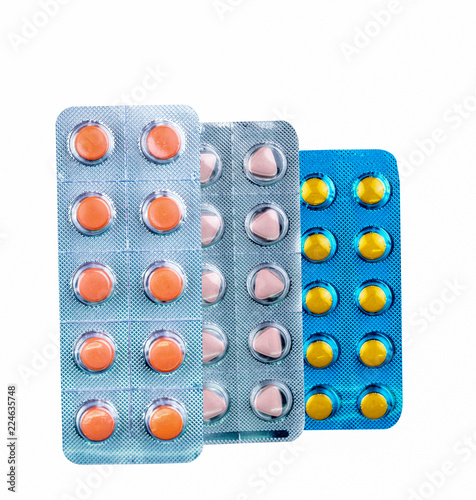 Diclofenac in blister pack isolated on white background. Drug with round and triangle shaped in pack. Film coated tablets. Orange, yellow, and pale pink tablets pills. Painkiller medicine. Pharmacy. photo