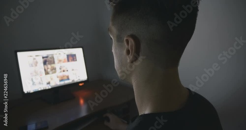 Young Man secretly watching porn sites at night.