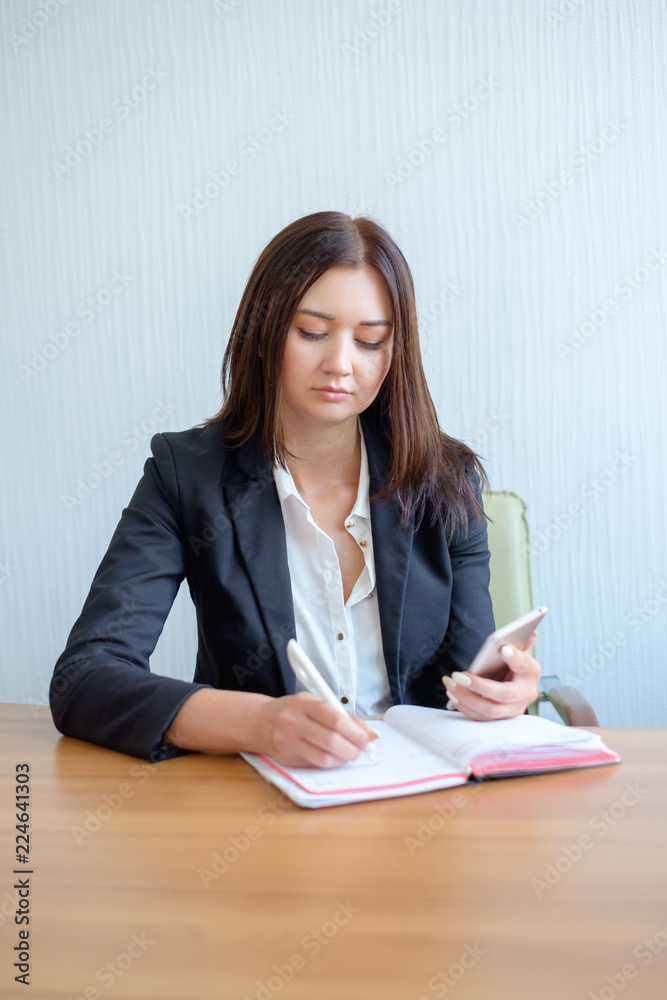 Busy female office worker going to make notes Busy female office worker going to make notes