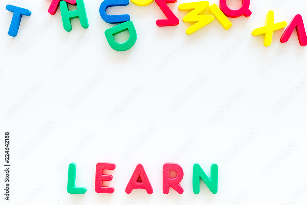 Children learn read concept. Word learn written by plastic letters on white background top view copy space