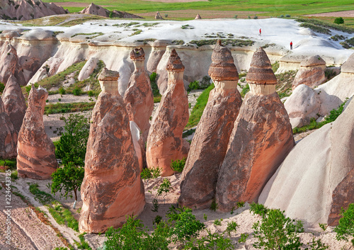 Tourism, recreation. Scenic rocks in Cappadocia (Turkey) with small figures of tourists for scale.