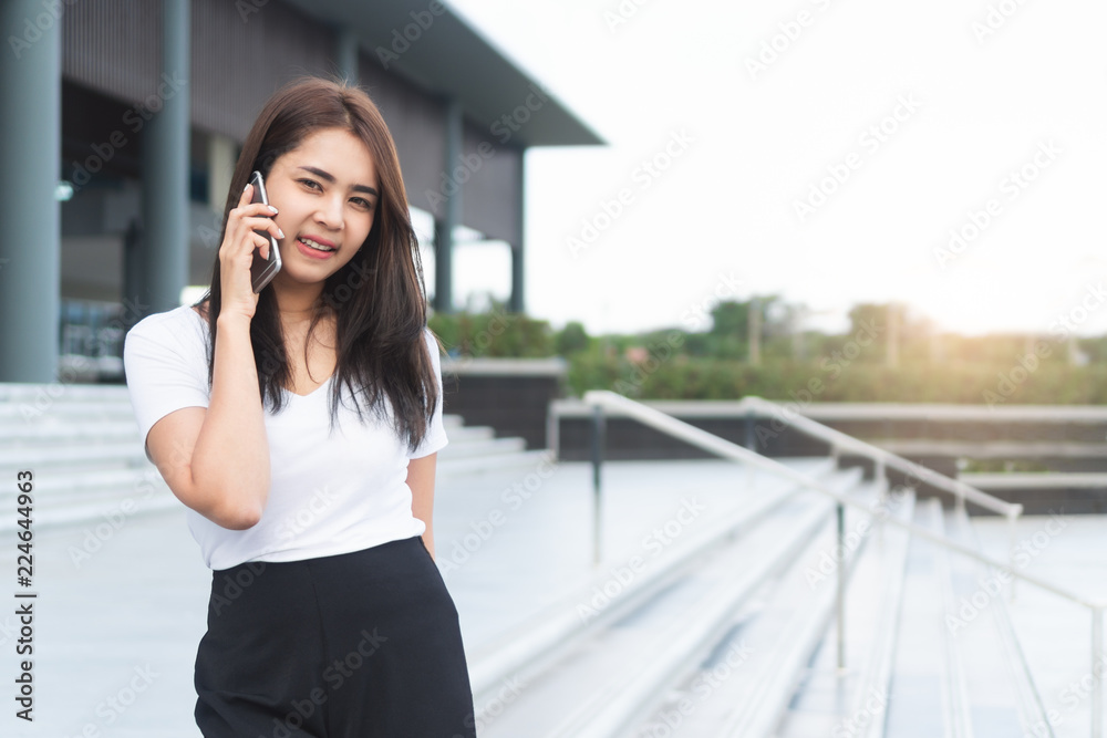 Young asian female student college calling someone on phone and looking to you. Young asian female student college calling someone on phone and looking to you.