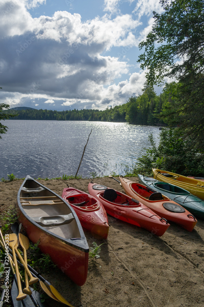 Kayaks and a canoe by the Indian lake in upstate NY (USA)
