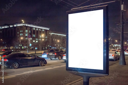 Blank place for your advertising. Mock up of light box in a city near traffic jam at night