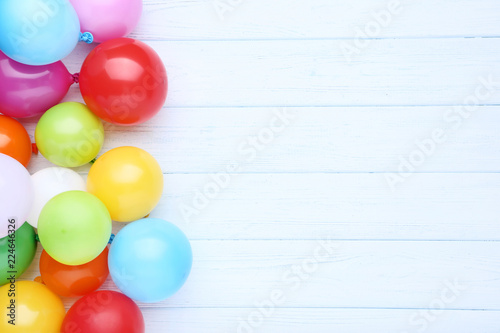 Colorful balloons on white wooden table