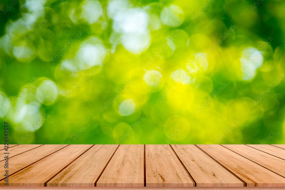 Old wood plank with abstract natural green blurred bokeh background for product display Old wood plank with abstract natural green blurred bokeh background for product display