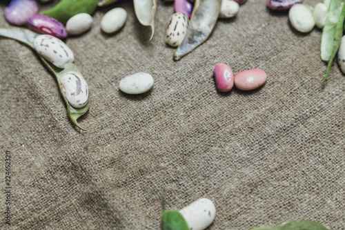 Multicolored beans lie on burlap