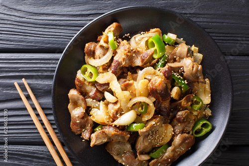 Billede på lærred Dak-ttongjip is a Korean dish made by stir-frying chicken gizzard with spices close-up on a plate