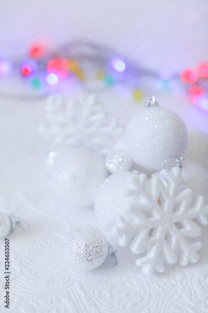 new year or Christmas decorations in silver and white colors with balls, snowflakes and garland bokeh new year or Christmas decorations in silver and white colors with balls, snowflakes and garland bokeh
