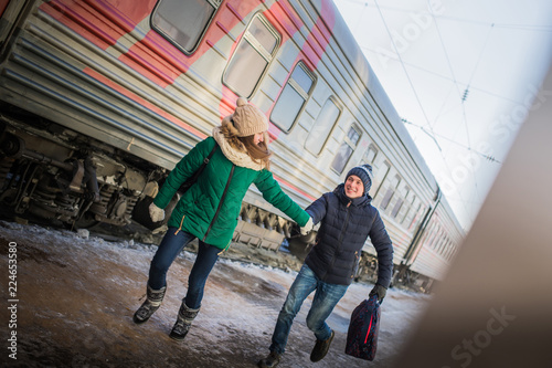 Couple is late for the train at railway station © keleny