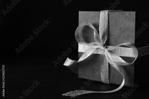 Wallpaper Mural Black gift box with silver ribbon bow on black background Torontodigital.ca