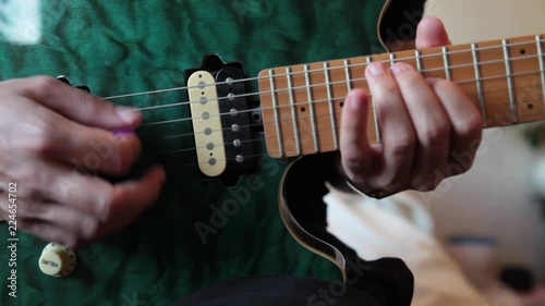 Young man playing a blue electric guitar