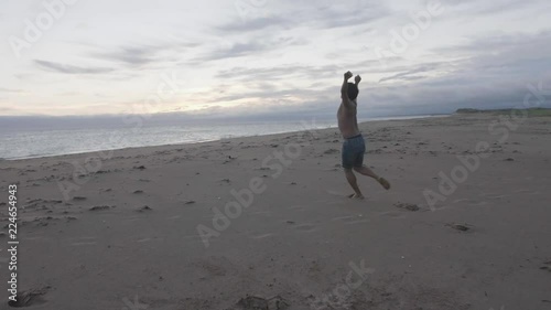 Dancer jumping near the ocean photo