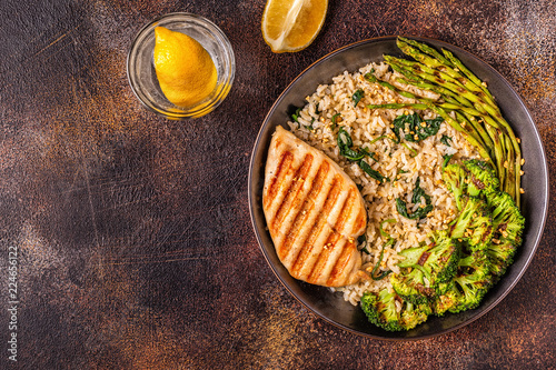 Grilled chicken breast with brown rice, spinach, broccoli, asparagus photo