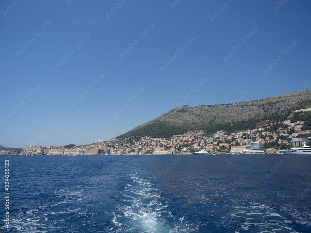 View of Dubrovnik old town during a boat tour in a sunny summer day. Dubrovnik, Croatia View of Dubrovnik old town during a boat tour in a sunny summer day. Dubrovnik, Croatia