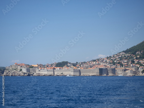 Fototapeta Naklejka Na Ścianę i Meble -  View of Dubrovnik old town during a boat tour in a sunny summer day. Dubrovnik, Croatia