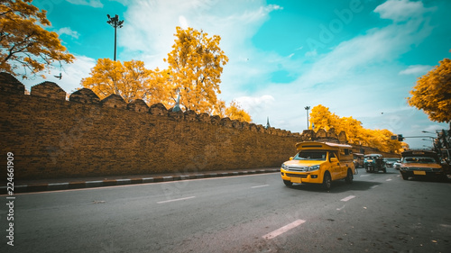Tuk Tuk and yellow car taxi for traveler in Tha pae Gate Chiang mai Thailand photo