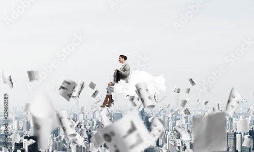 Woman float above city on cloud and papers flying around