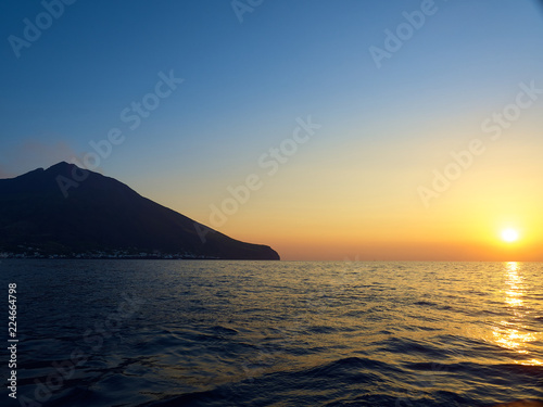 Shooting the volcano at sunset from the boat © gpiazzese
