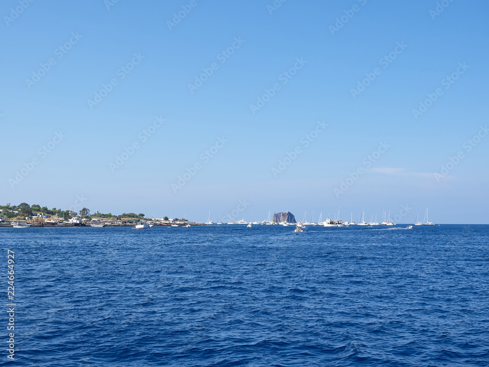 Shot of Strombolicchio and Stromboli islands from the boat in a summer afternoon