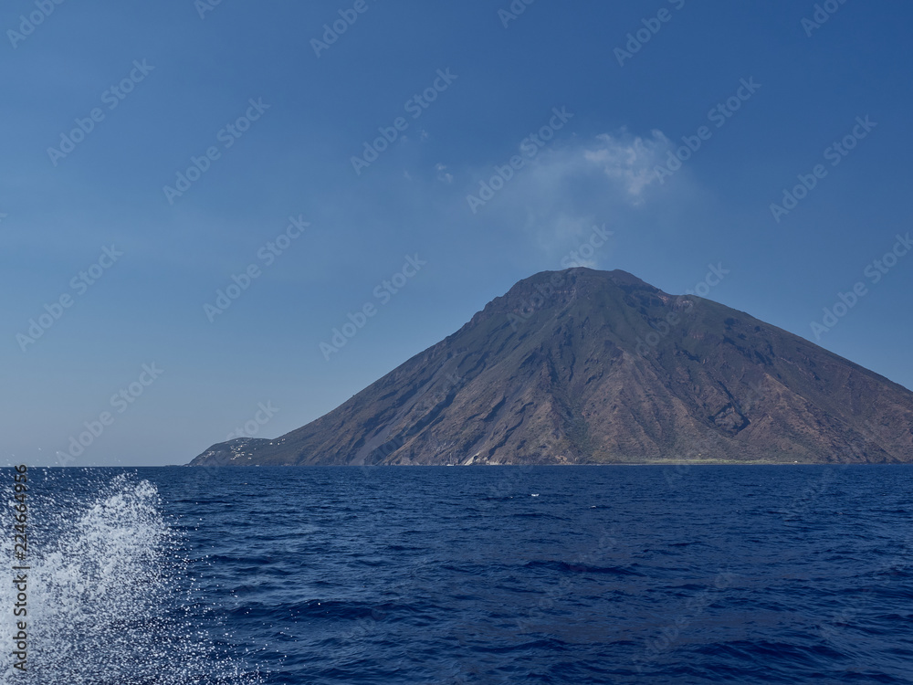 View of Stromboli island and volcano from the boat in a summer afternoon