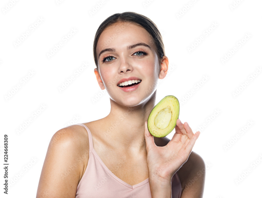 portrait of attractive young caucasian smiling cheerful woman isolated on white studio shot eating avocado lookıng at camera toothy smıle portrait of attractive young caucasian smiling cheerful woman isolated on white studio shot eating avocado lookıng at camera toothy smıle