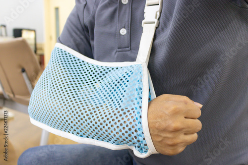 Arm of wounded man who is wearing a hanging mesh