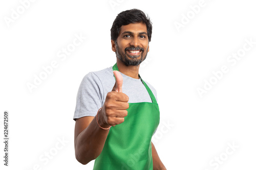 Supermarket staff making thumb up gesture photo